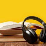 Photo of headphones atop an open book