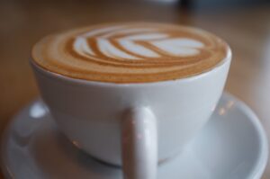 Photo of cappuccino with leaves drawn in the foam